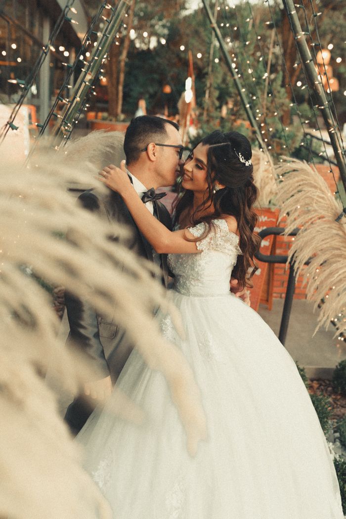 Bride and groom sharing a romantic moment in a beautifully decorated outdoor setting.